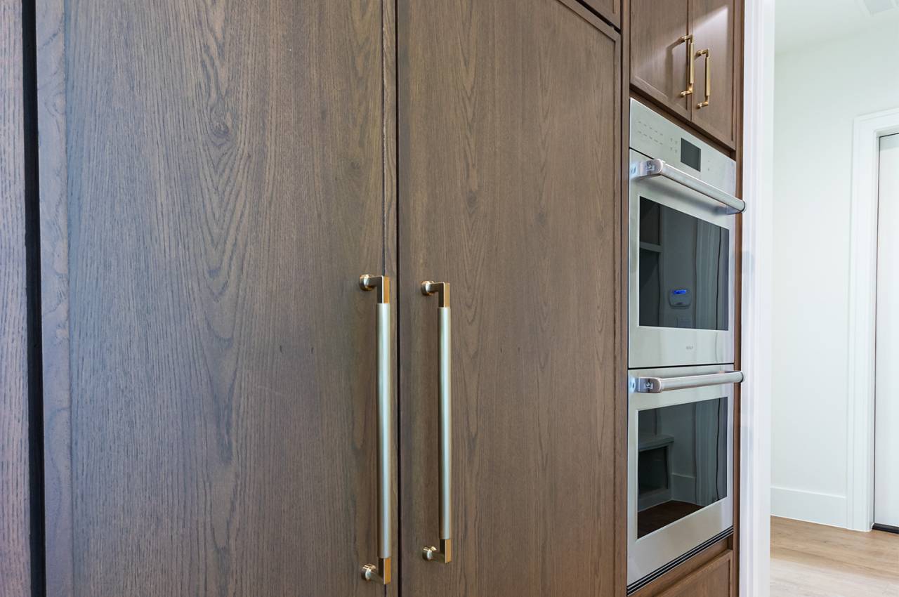 Gorgeous wood paneled 42" Sub-Zero refrigerator with double convection oven.