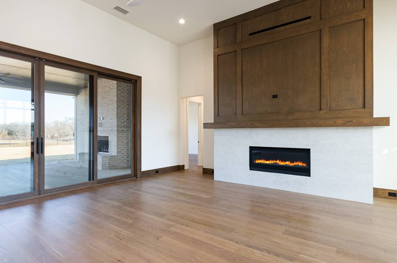 Wood paneling above the 55" linear fireplace in the family room adds an extra decorator touch!