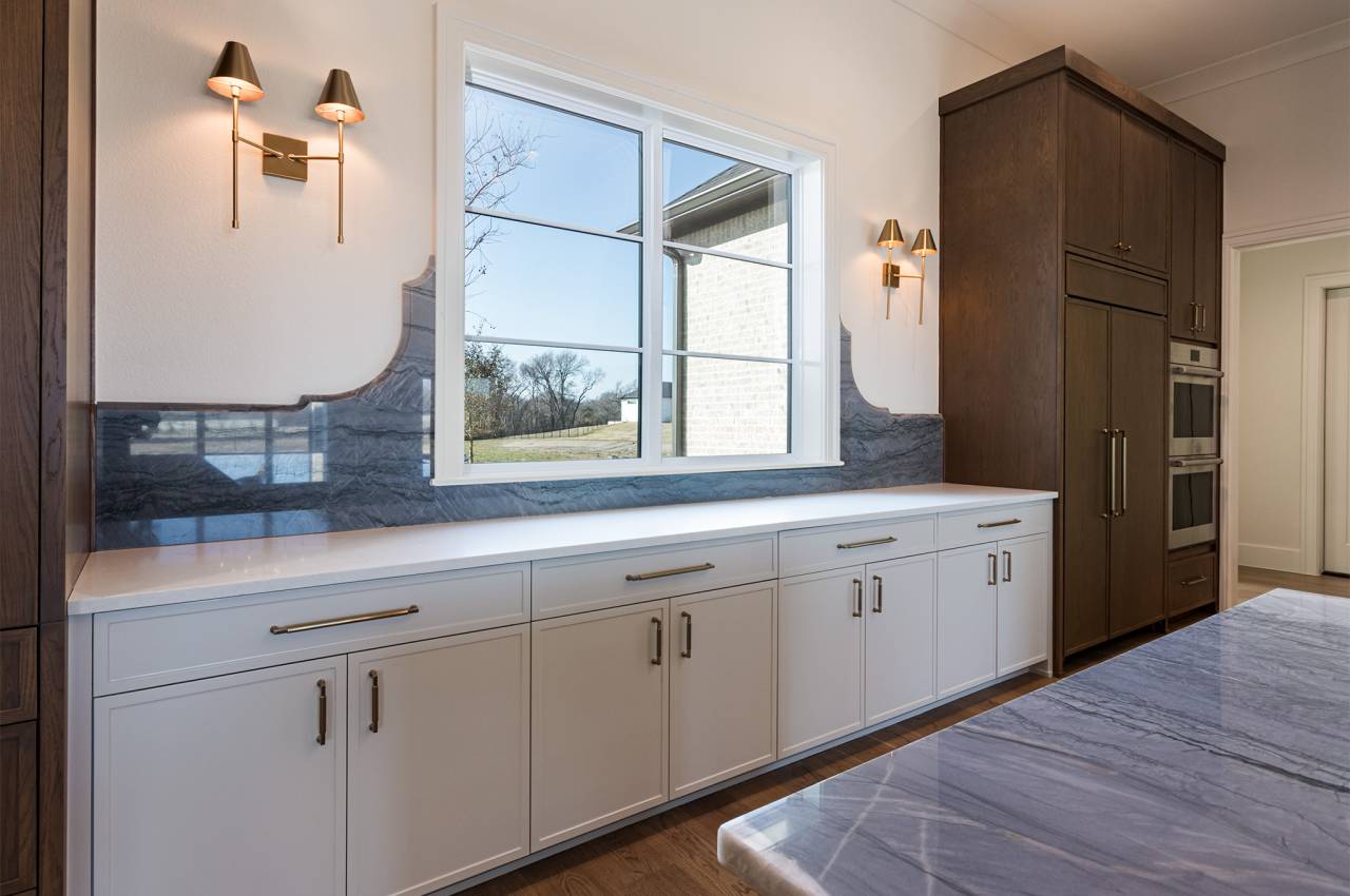 Kitchen window overlooks the front yard.  Designer backsplash, decorative lighting and hardware with ample storage space!