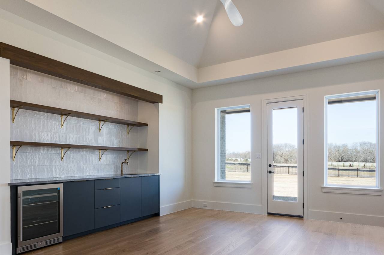 The Activity Room is ready for fun with a bar - sink and under counter refrigerator - and lots of cabinets for games and shelves for your collectibles!