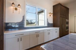 Kitchen window overlooks the front yard.  Designer backsplash, decorative lighting and hardware with ample storage space!